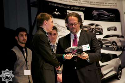 Daniel Kangas receiving design award from Patrick Ayoub.
