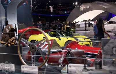 View of the Alfa Romeo booth with vintage alfa parts in the forground